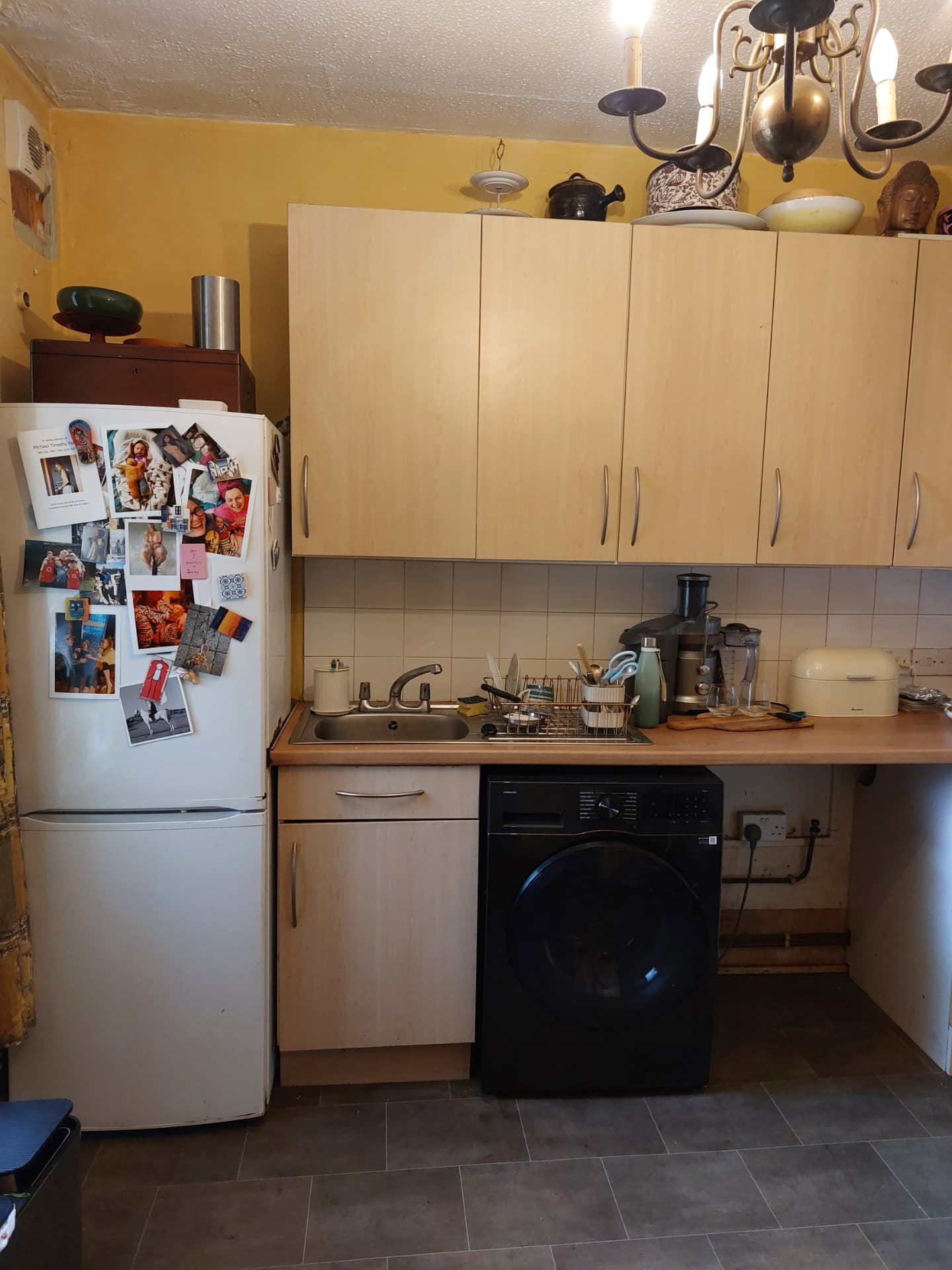 Original kitchen with dated wood-effect wall and base units and small sink