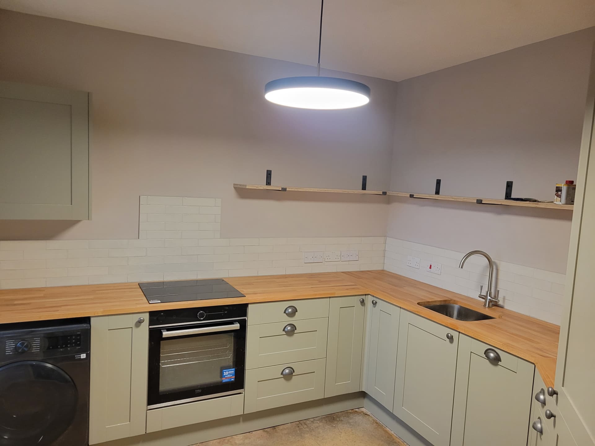 Finished kitchen with painted cabinets and solid timber worktops