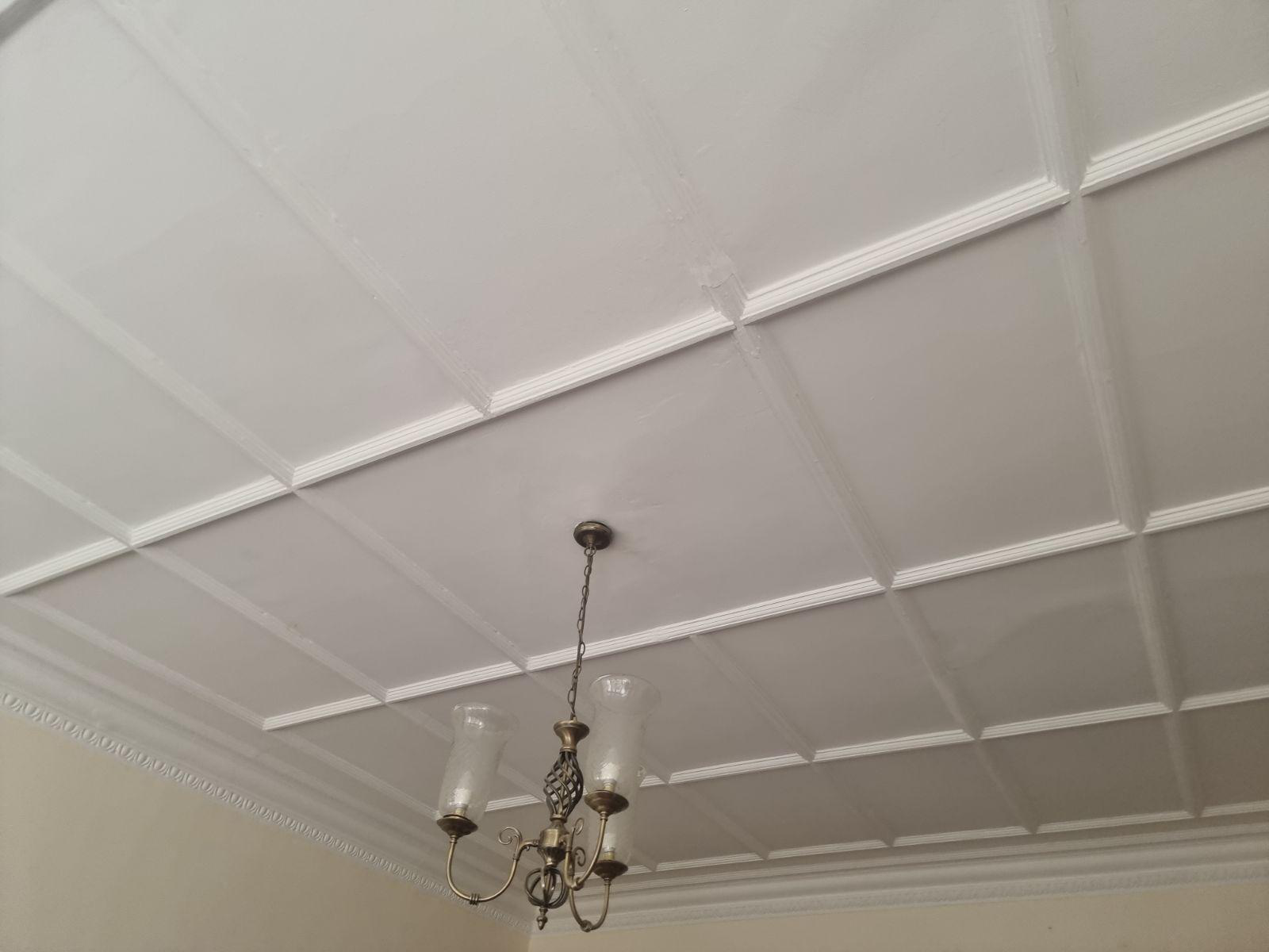 Close-up of the restored coffered ceiling with decorative plaster cornice