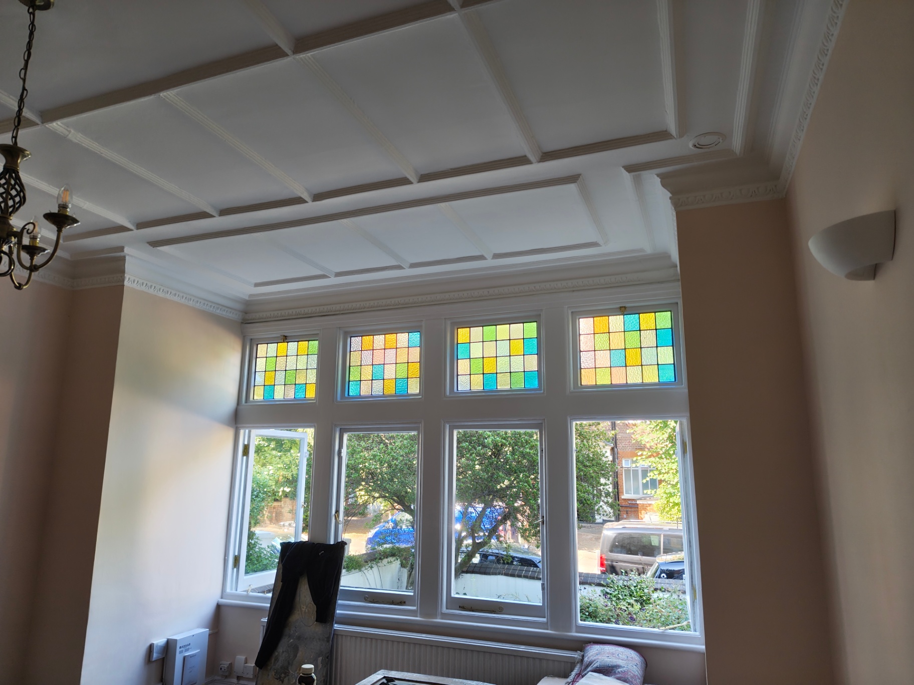 Restored bay window with original stained glass and coffered ceiling detail