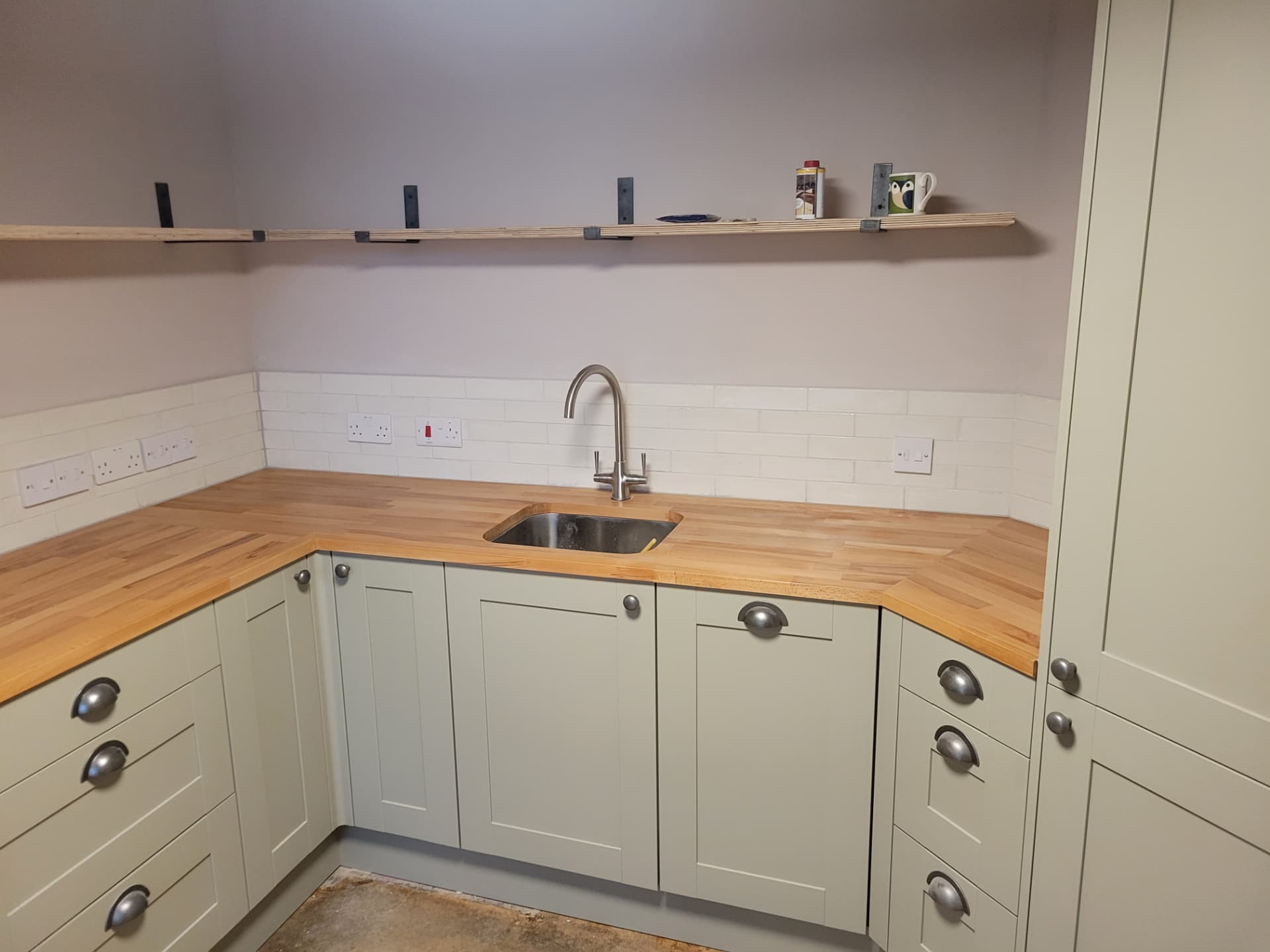Finished kitchen detail with tiling and open shelving